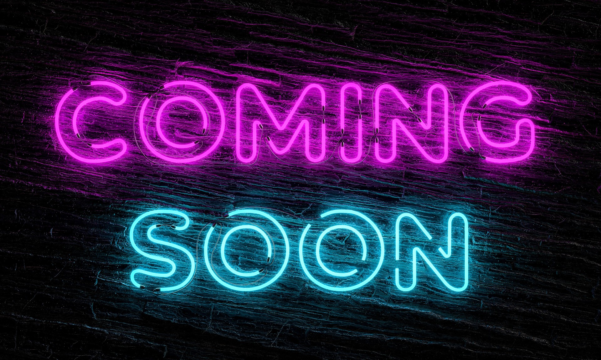 Coming soon neon sign on dark wooden background
